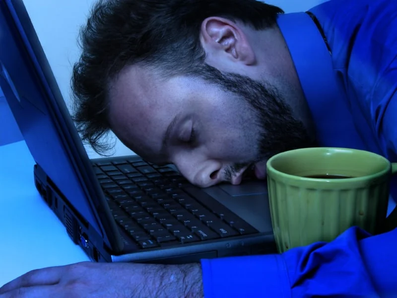 Man sleeping at laptop computer