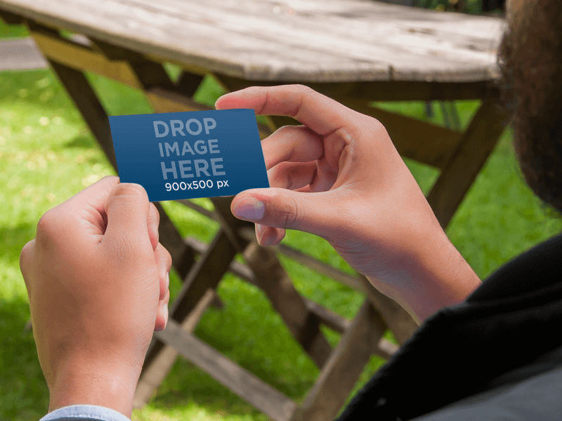 PRINT DESIGN MOCKUP, MAN HOLDING BUSINESS CARD OUTSIDE