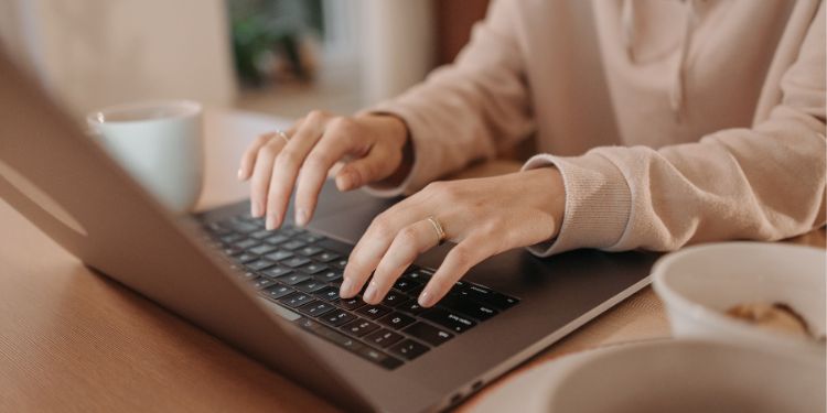donna che digita su un computer alla sua scrivania